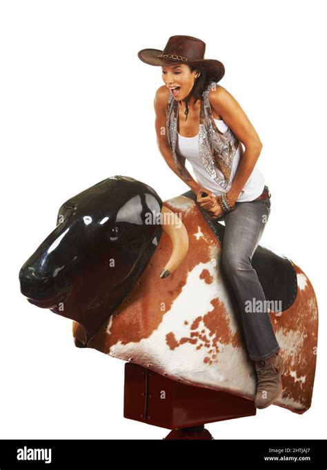 Cool Brunete Girl in Dress Riding on a Mechanical Bull in。